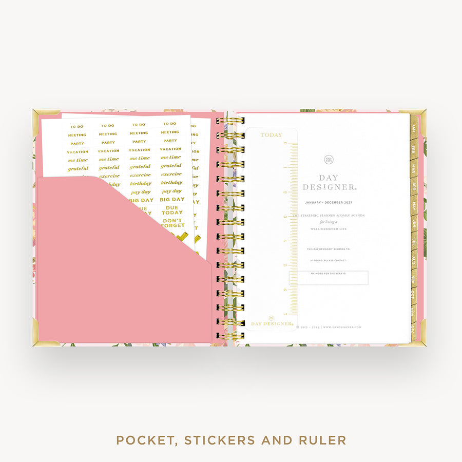 An open Day Designer pocket planner with a pink pocket, gold ring binder, and white inserts, shown on a light gray background with the text 'POCKET, STICKERS AND RULER' below.
