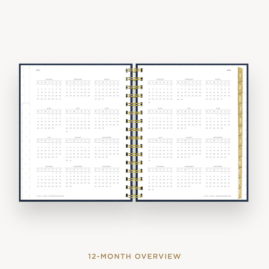 An open spiral-bound planner showing a 12-month calendar overview spread on a light gray background, with the text '12-MONTH OVERVIEW' below.