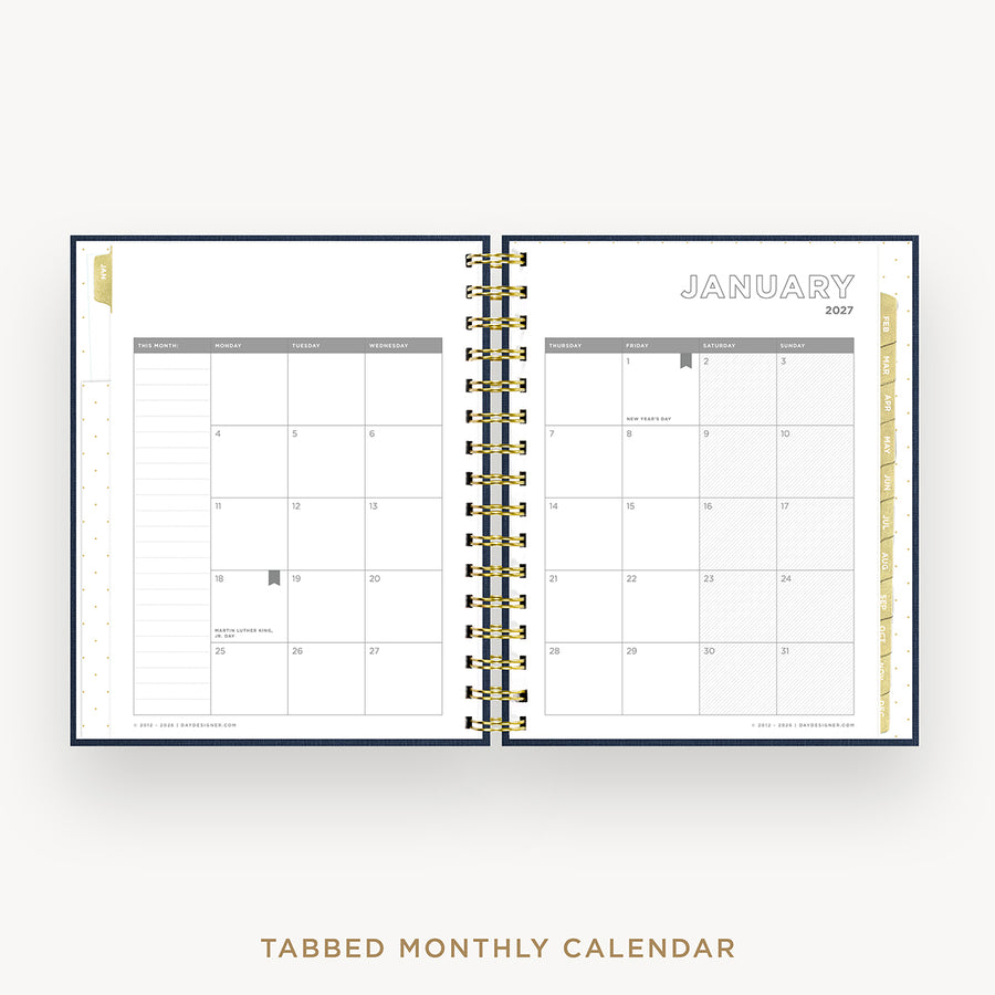 An open spiral-bound monthly calendar planner showing January 2027, with tabbed pages and gold-toned binding, photographed on a light gray background with the text 'TABBED MONTHLY CALENDAR' below.