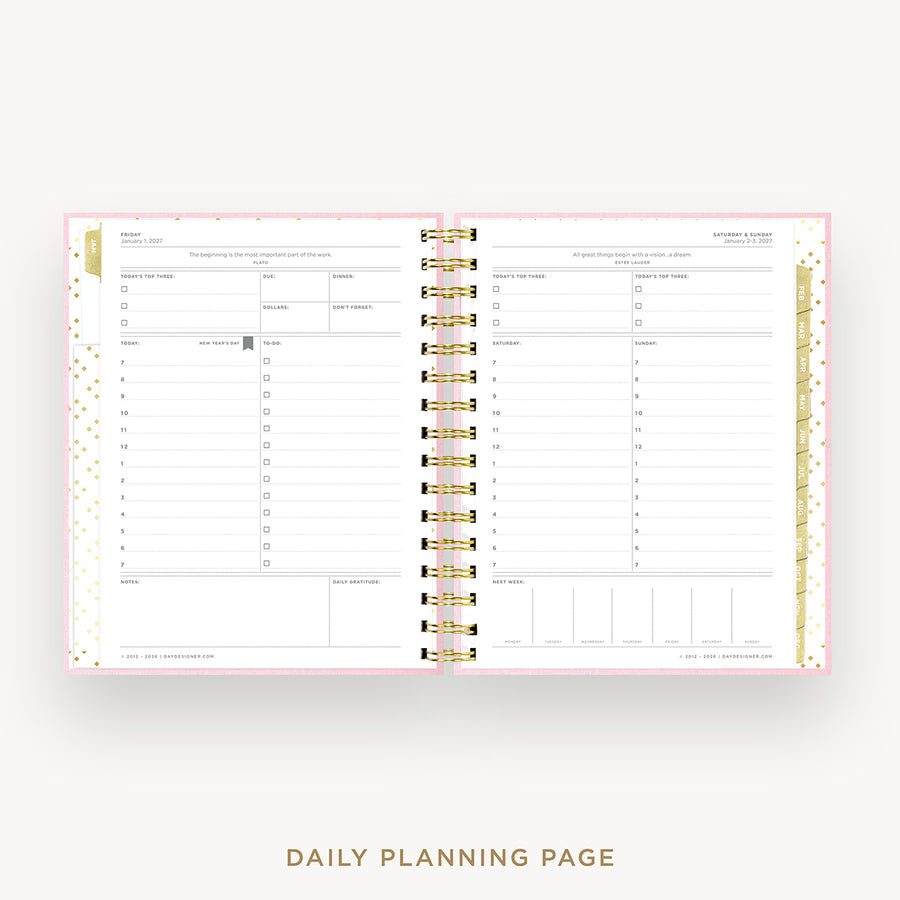 An open spiral-bound daily planner showing two lined daily planning pages with gold rings and a pink border, displayed on a light gray background with the text 'DAILY PLANNING PAGE' below.