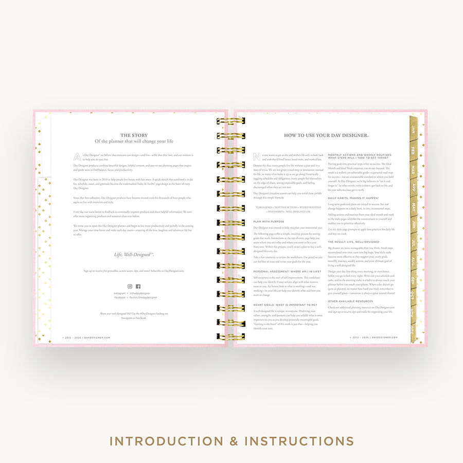An open spiral-bound booklet or planner showing printed introduction and instructions pages, with a light pink border and gold accents, centered on a light gray background with the text 'INTRODUCTION & INSTRUCTIONS' below.