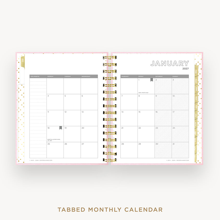 An open tabbed monthly calendar planner shown on a light gray background. The pages are white with gold and gray accents, including a gold polka-dot pattern on the left page, a gold ring binder in the center, and 'JANUARY 2027' printed at the top right.
