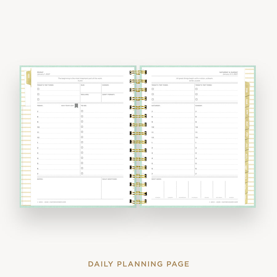 An open spiral-bound daily planner showing two lined daily planning pages with gold ring binding, on a light gray background with the text 'DAILY PLANNING PAGE' below.