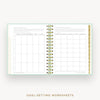 An open spiral-bound planner or notebook showing two pages filled with goal-setting worksheet tables and text, on a light neutral background with the words 'GOAL-SETTING WORKSHEETS' below.