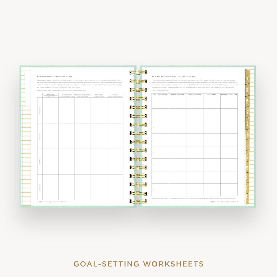 An open spiral-bound planner or notebook showing two pages filled with goal-setting worksheet tables and text, on a light neutral background with the words 'GOAL-SETTING WORKSHEETS' below.