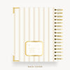 A spiral-bound notebook shown from the back cover, featuring vertical cream and gold stripes, gold corner accents, and a gold label near the bottom. The text 'BACK COVER' appears below the notebook on a clean white background.