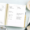 Day Designer 2024-25 daily planner: Black Stripe opened with writing on it