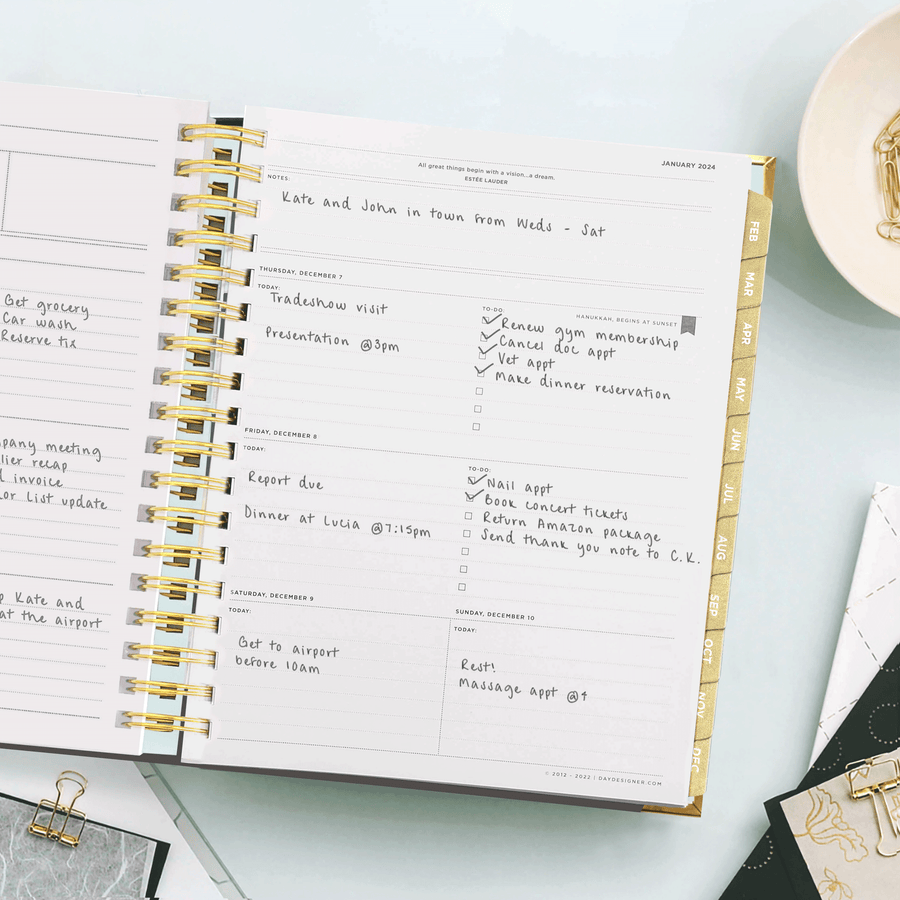 Day Designer 2024 weekly planner: Black Stripe opened with writing on it