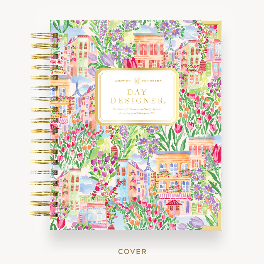 Colorful planner cover with floral and building design, featuring 'Day Designer' branding.
