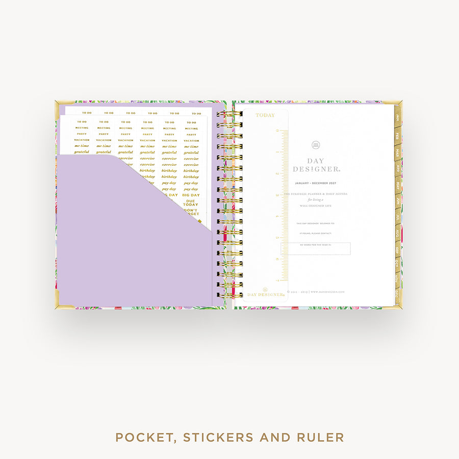 Open planner showing a pocket, stickers, and ruler on a white background