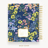 Floral-patterned notebook with gold binding on a white background