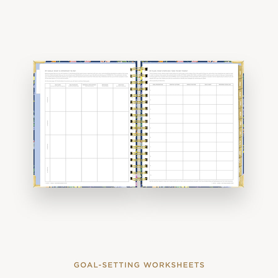 Open wire-bound notebook displaying goal-setting worksheets on a white background.