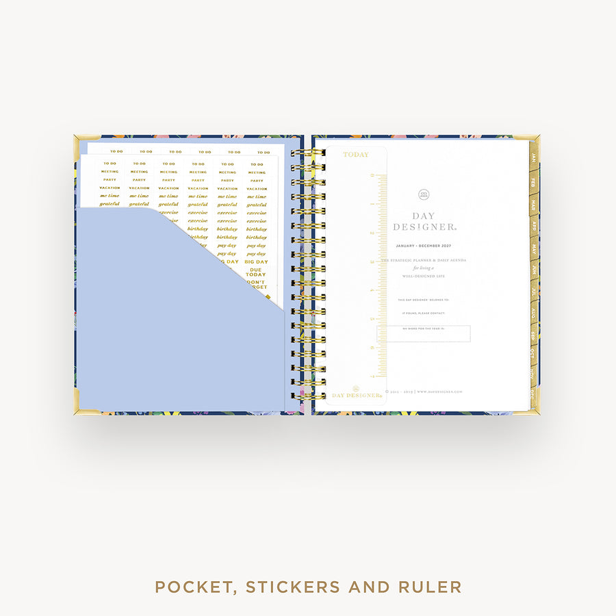 Open planner showing a pocket, stickers, and ruler section on a white background