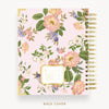 Floral patterned notebook with gold accents on a white background