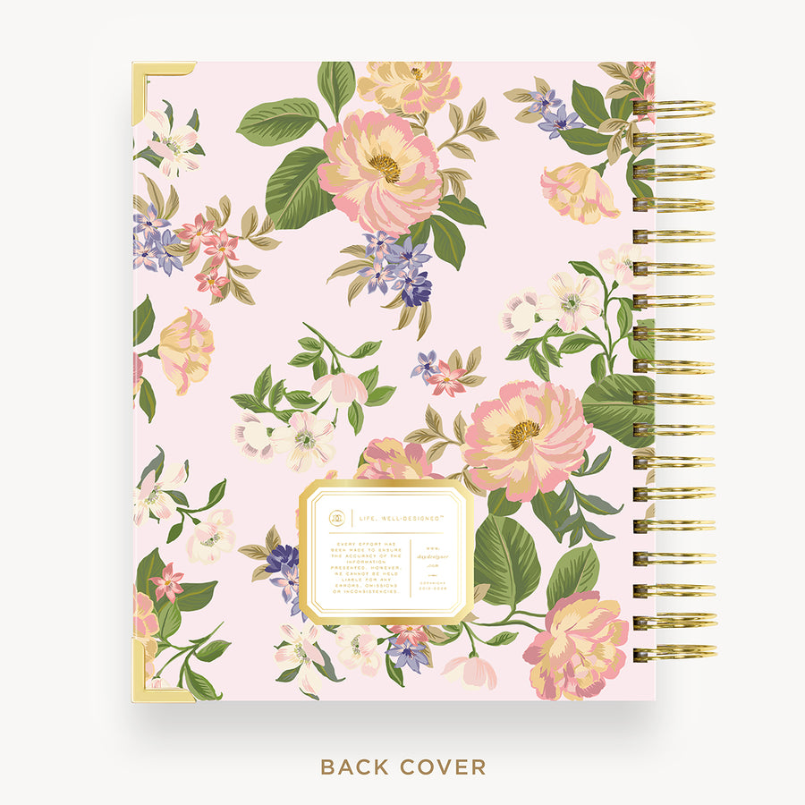 Floral patterned notebook with gold accents on a white background