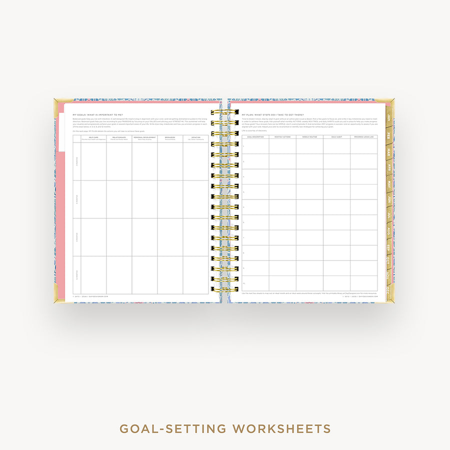 Open wire-bound notebook displaying goal-setting worksheets on a white background.