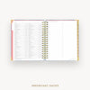 Wire-bound planner with a pink cover and white pages on a white background
