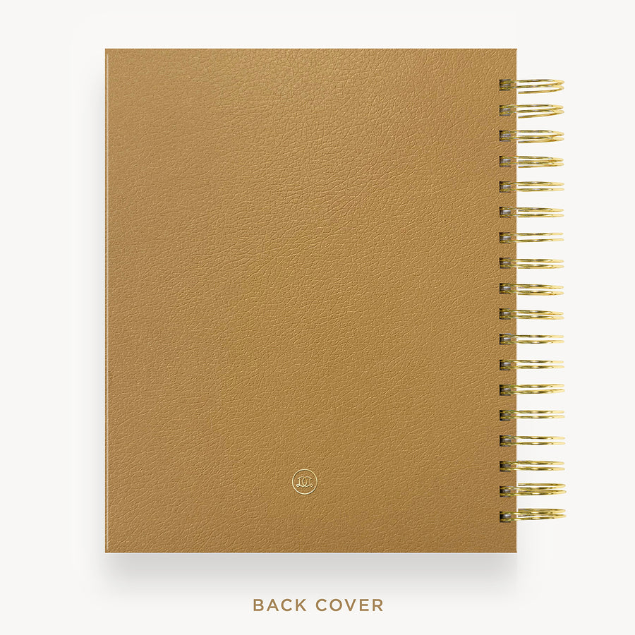 Caramel planner with gold spiral binding on a white background
