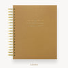 Brown planner with gold spiral binding  and visible day designer branding on a white background