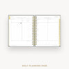 Wire-bound planner with daily planning pages on a white background
