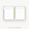 Open planner with goal-setting worksheets on a white background