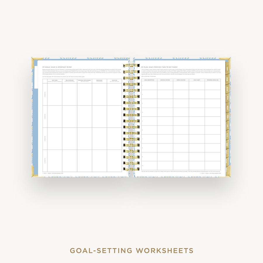 Open planner with goal-setting worksheets on a white background