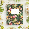 Floral notebook with 'Day Designer' branding on a decorative table setting.