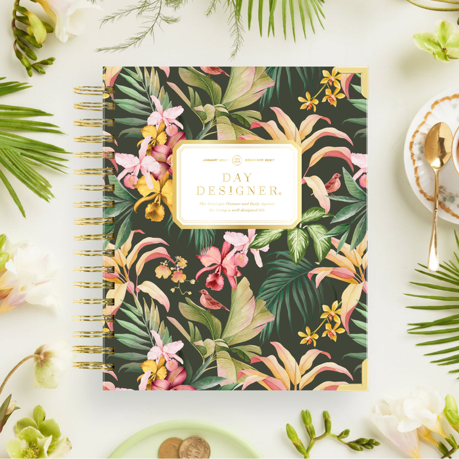 Floral notebook with 'Day Designer' branding on a decorative table setting.