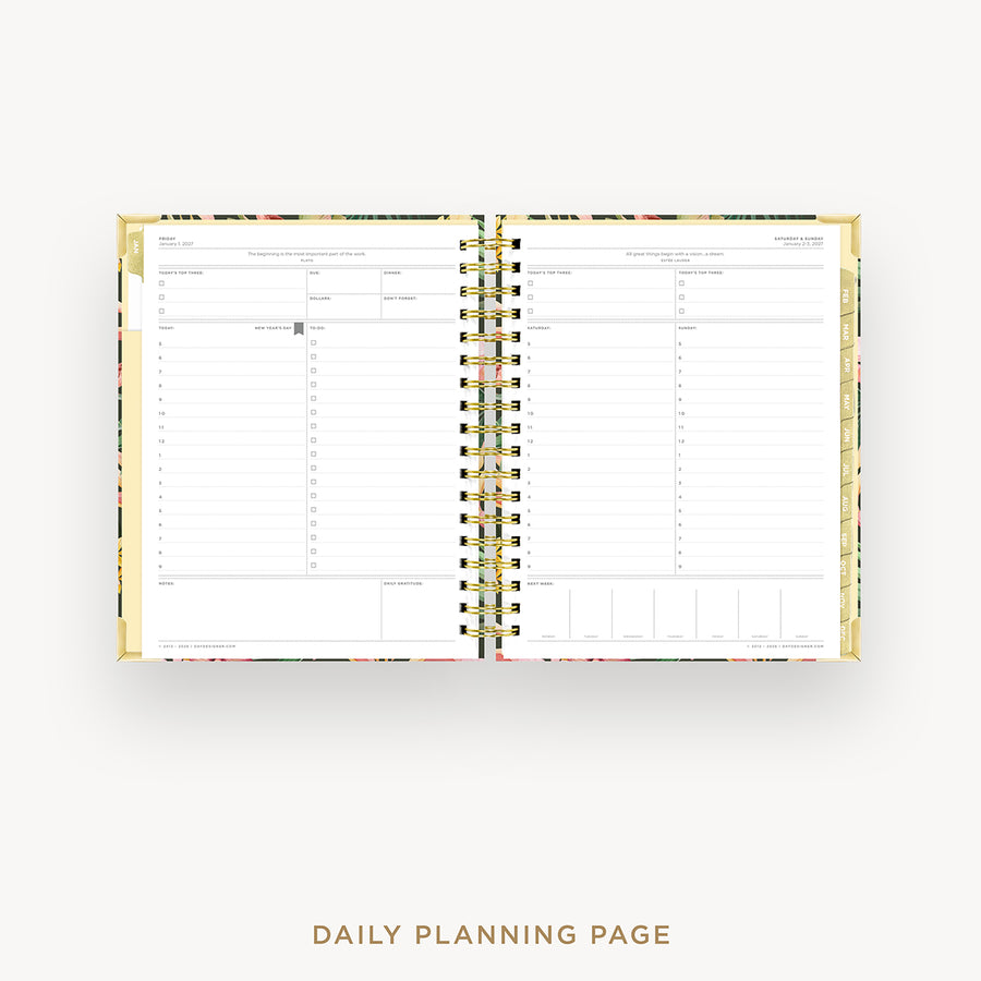 Open daily planner with gold binding on a white background
