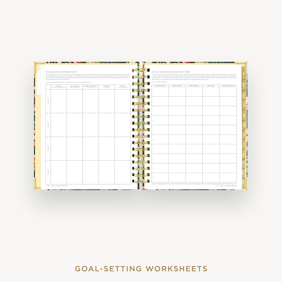 Open planner with goal-setting worksheets on a white background