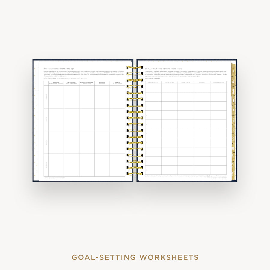Open wire-bound notebook displaying goal-setting worksheets on a white background.