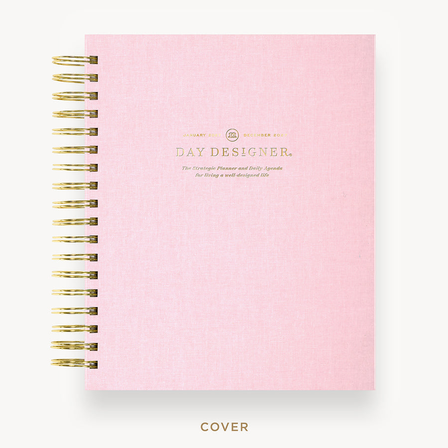 Pink planner with gold accents on a white background