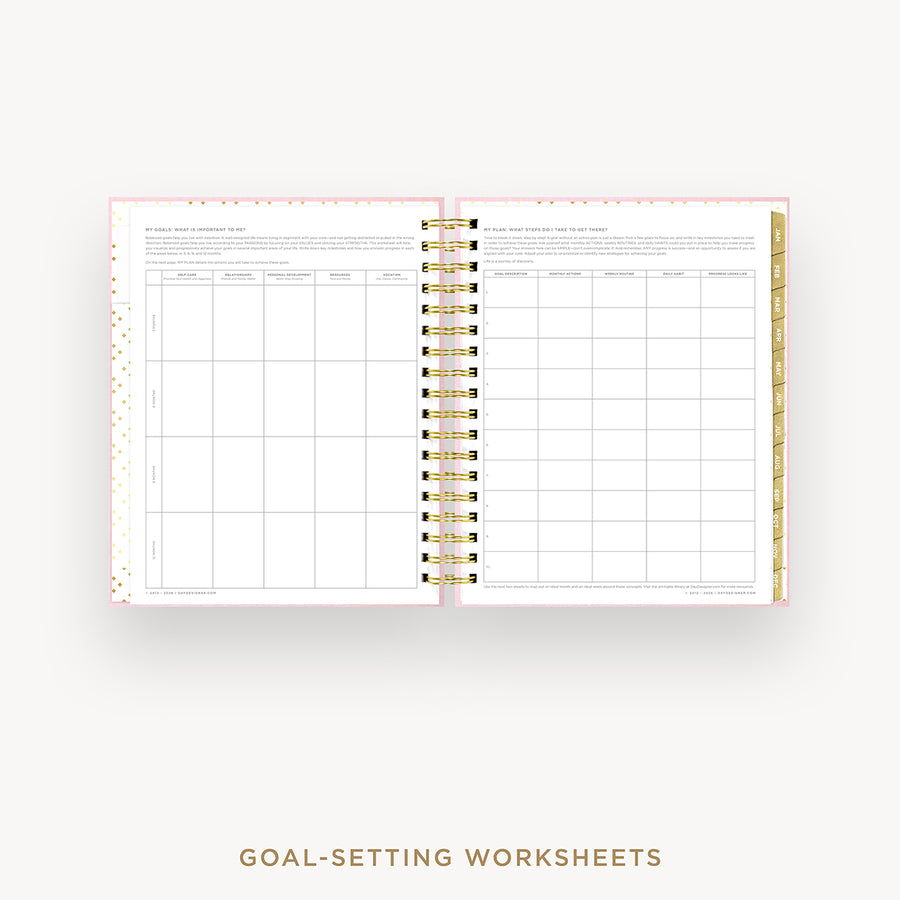 Goal-setting worksheets in a spiral-bound notebook on a white background