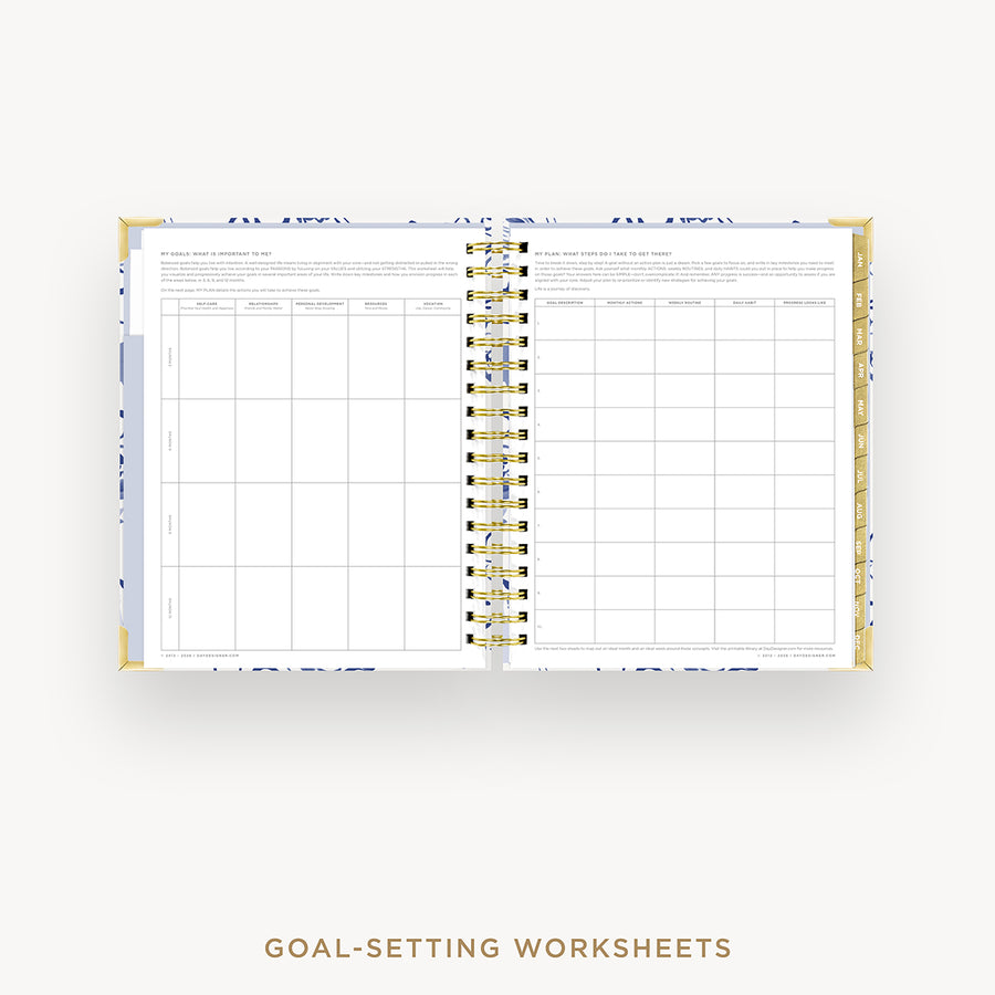 Open planner showing goal-setting worksheets on a white background
