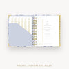 Open planner showing pages with pocket, stickers, and ruler on a white background