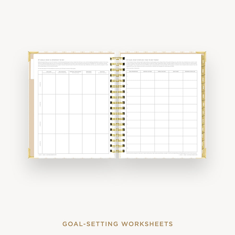 Open planner with goal-setting worksheets on a white background