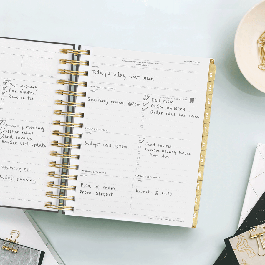 Day Designer 2024 mini weekly planner: Black Stripe opened with writing on it