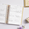Day Designer 2024 mini weekly planner: Blurred Spring opened with writing on it