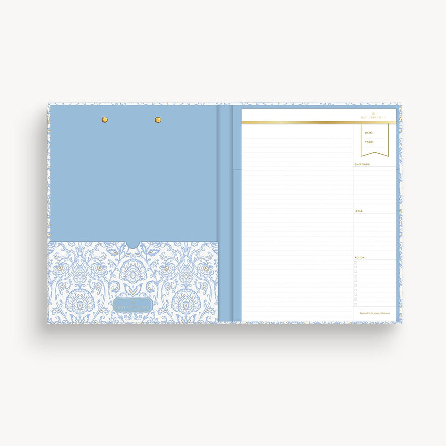 light blue and gold pattern clipfolio with light blue interior pocket and lined pad on a cream background