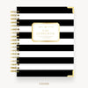 Black and white striped notebook with gold accents on a white background
