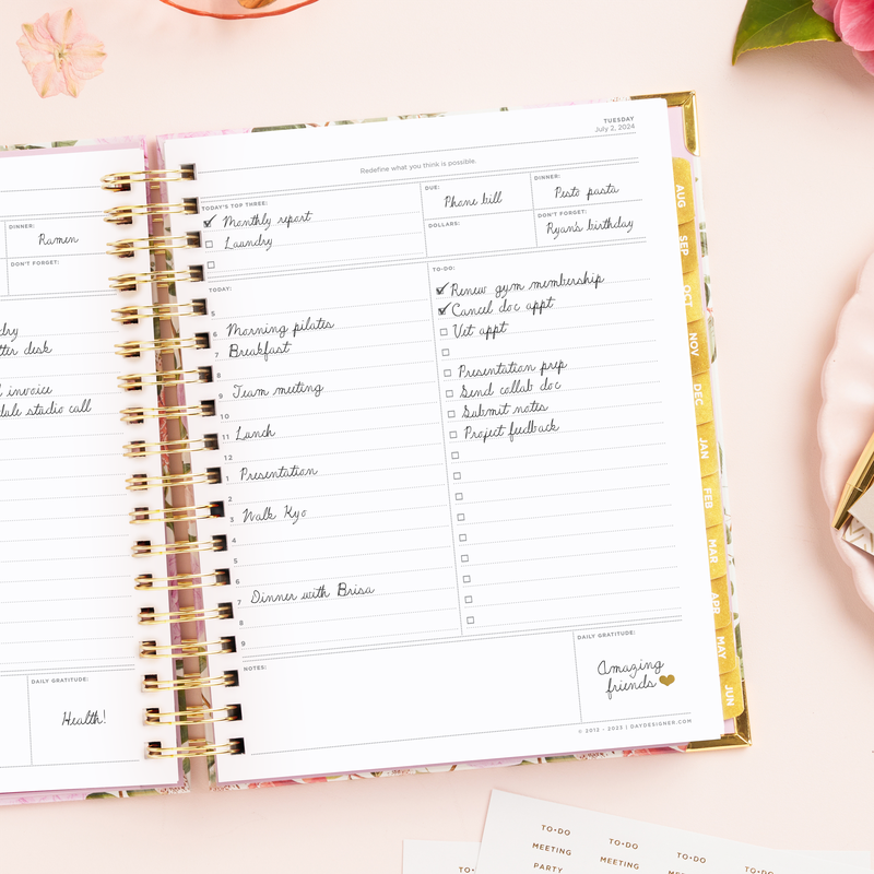 Day Designer 2024-25 daily planner: Camellia opened with writing on it