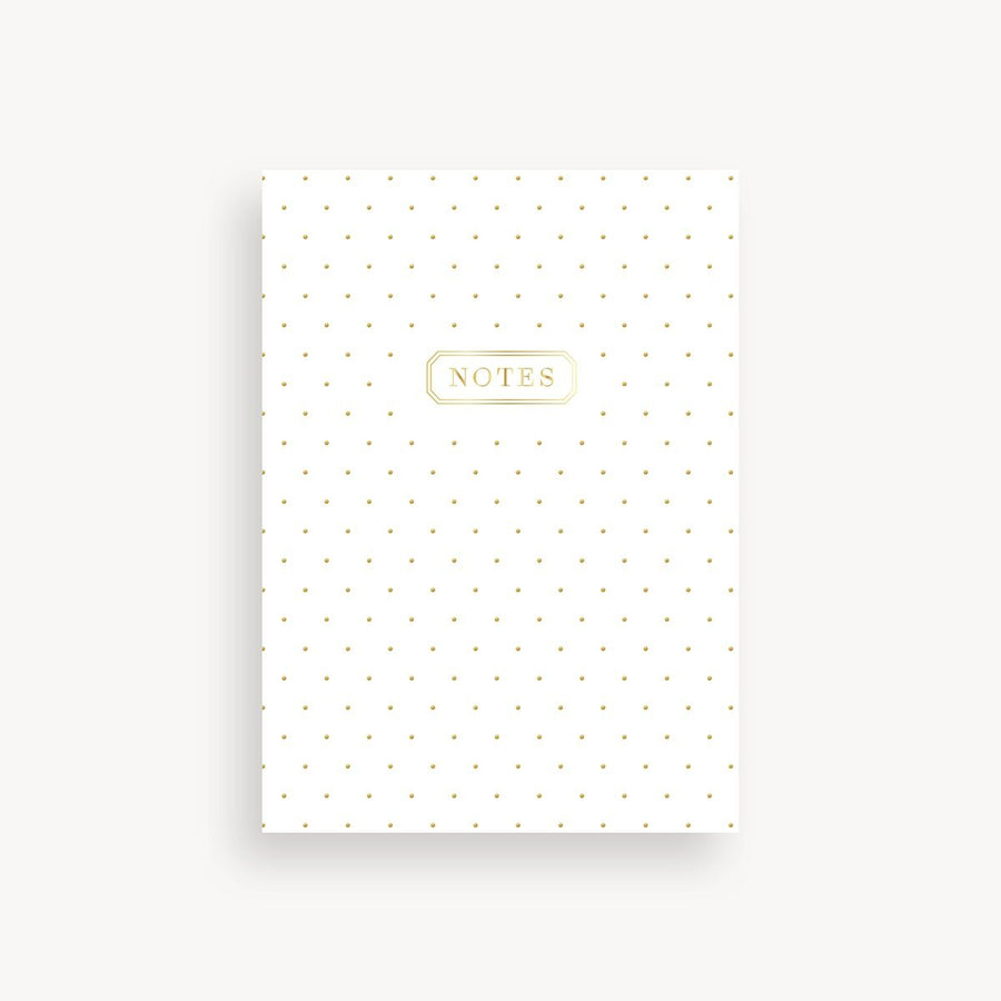 White notebook with gold polka dots and 'NOTES' label on a white background