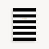 Notebook with black and white horizontal stripes on a light gray background