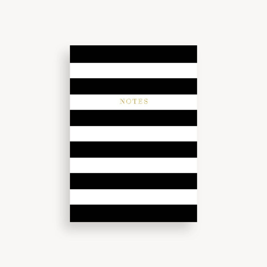 Notebook with black and white horizontal stripes on a light gray background