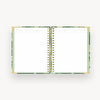 open notebook with lined notes pages, green liner