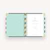 Open planner showing two pages with a mint green cover and white back page on a white background.