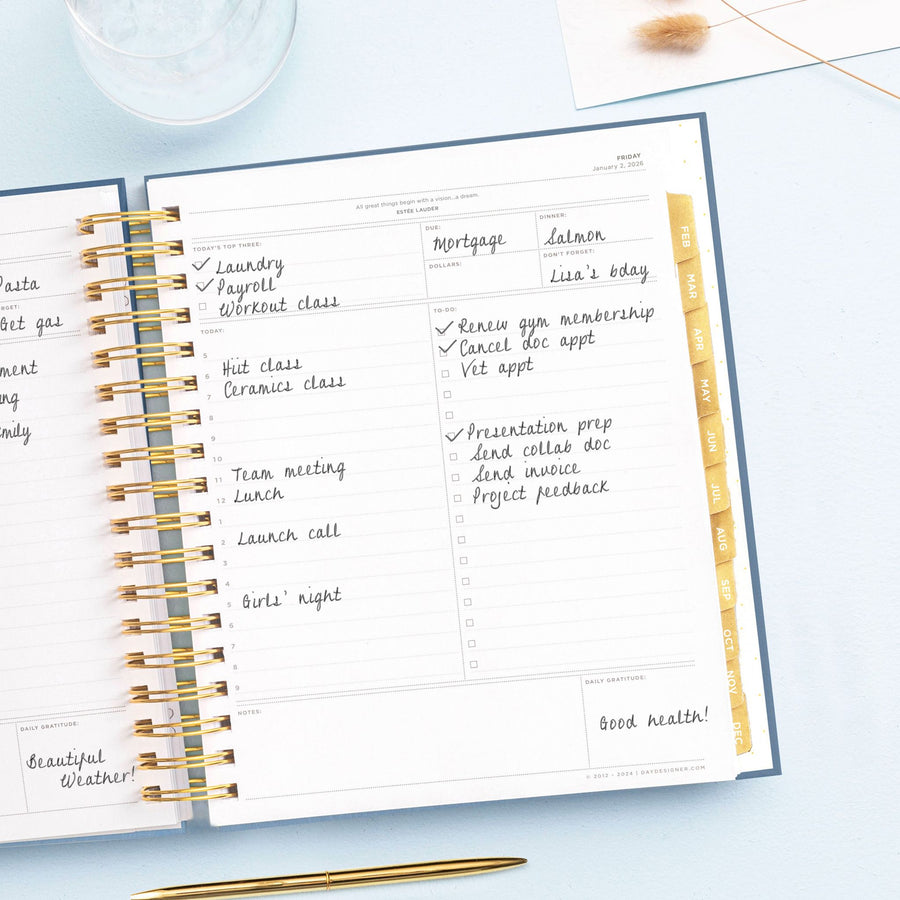 Day Designer 2026 daily planner: navy bookcloth opened with writing on it