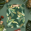 clipfolio with green and gold tropical leaves on dark green background, bottle, acorns, leaves