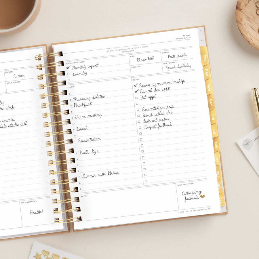 Day Designer 2026 daily planner: caramel latte pebble texture opened with writing on it