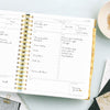 Day Designer 2026 daily planner: black stripe opened with writing on it